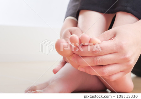 Young woman touching her toes Young woman touching her toes 108515330