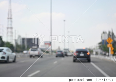 highway traffic with safety barrier on road asphalt, blurred image 108515895