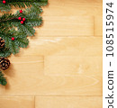 Christmas background of green fir branches with red berries and brown cones. 108515974