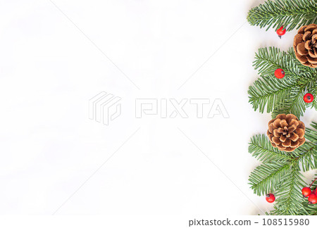 Christmas flat lay composition. Green branches with red berries and brown cones on white background. 108515980