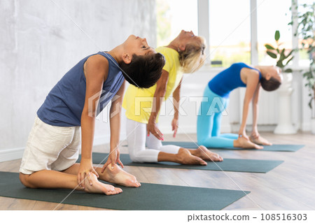 Yoga class generation doing Camel pose. 108516303