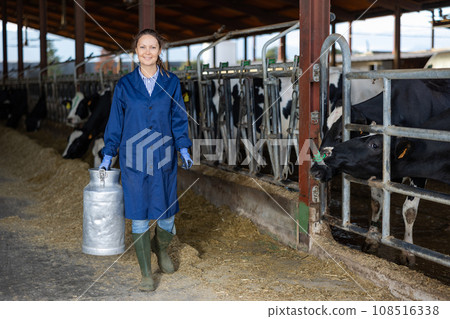 Woman dairy farm worker with milk can Woman dairy farm worker with milk can 108516338