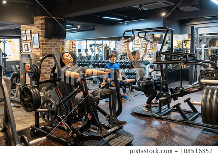 Fitness gym training young men and women 108516352