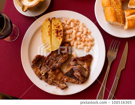 Delicious fried lamb ribs with boiled potatoes and beans Delicious fried lamb ribs with boiled potatoes and beans 108516365