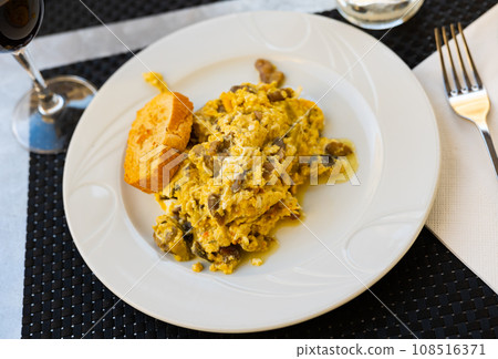 Just cooked scrambled eggs with asparagus and mushrooms served on table and ready-to-eat. Just cooked scrambled eggs with asparagus and mushrooms served on table and ready-to-eat. 108516371