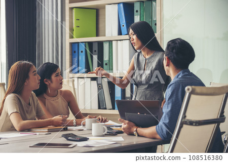 Happy business people meeting present graph chart investment, business data in meeting room. Group of business people meeting in conference room. Asian businessman speech, present teamwork partnership Happy business people meeting present graph chart investment, business data in meeting room. Group of business people meeting in conference room. Asian businessman speech, present teamwork partnership 108516380