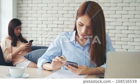 Happy success business woman partner working together in company office corporate executive teamwork. Meeting Executive Asian business woman using laptop office desk with fist arm raised win happiness Happy success business woman partner working together in company office corporate executive teamwork. Meeting Executive Asian business woman using laptop office desk with fist arm raised win happiness 108516539