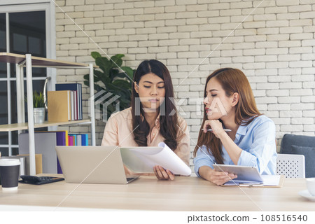Happy success business woman partner working together in company office corporate executive teamwork. Meeting Executive Asian business woman using laptop office desk with fist arm raised win happiness Happy success business woman partner working together in company office corporate executive teamwork. Meeting Executive Asian business woman using laptop office desk with fist arm raised win happiness 108516540