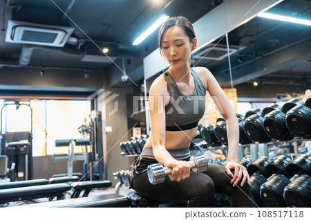 Young woman doing muscle training at the gym Young woman doing muscle training at the gym 108517118