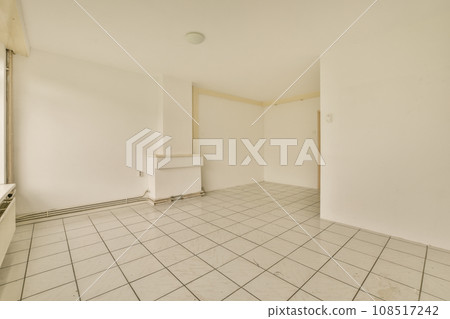 an empty room with white walls and tile flooring on the floor, there is no one person in it an empty room with white walls and tile flooring on the floor, there is no one person in it 108517242