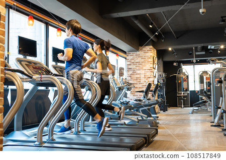 Sports gym running machine young men and women 108517849