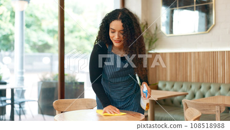 Waitress, woman and cleaning table in coffee shop for dust, bacteria and dirt with cloth, spray or detergent. Barista, person and wipe wooden furniture in cafe or restaurant with chemical liquid 108518988