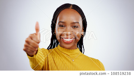 Thumbs up, woman and portrait in studio for success, winning deal and happy achievement on white background. African model, emoji and like sign for feedback, voting yes and thank you for excellence 108519238
