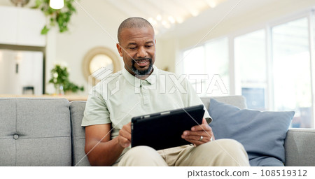 Technology, mature man with tablet and in living room of his home happy for social media. Online communication or networking, connectivity or leisure and black male person on couch with smile Technology, mature man with tablet and in living room of his home happy for social media. Online communication or networking, connectivity or leisure and black male person on couch with smile 108519312