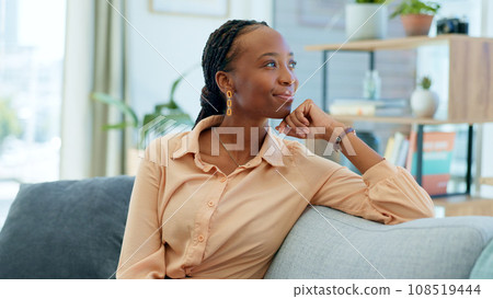 African woman, sofa and thinking in home living room with smile, memory or decision with vision. Person, relax and happy on lounge couch with ideas, solution and problem solving with brainstorming 108519444