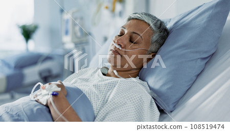 Sick, iv drip and senior woman in the hospital for consultation, surgery or treatment. Healthcare, recovery and elderly female patient resting in bed after operation or procedure in a medical clinic. 108519474