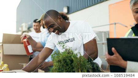 Volunteer, men and women with food boxes on table for charity event with care, kindness and smile. Community donation, help and team at ngo with grocery package distribution at non profit project. 108519484