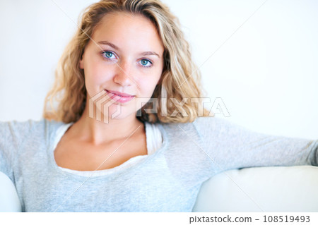 Woman, natural and beauty portrait on sofa for confident mindset, attractive or white wall background. Female person, face and smile for relax on couch or comfortable, feminine style mockup in Canada 108519493