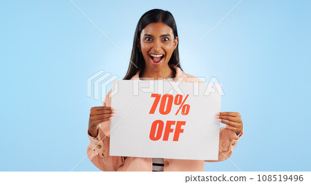 Woman, promotion poster and portrait with sale, discount and billboard in studio. Excited, smile and happy from savings and deal paper with banner and promo with blue background and price decrease Woman, promotion poster and portrait with sale, discount and billboard in studio. Excited, smile and happy from savings and deal paper with banner and promo with blue background and price decrease 108519496
