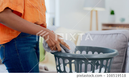 Hands, housework and woman folding laundry in a living room, cleaning and tidy in her home. Hand, girl and female with clean towels, sorting and packing on the weekend for hygiene and household task Hands, housework and woman folding laundry in a living room, cleaning and tidy in her home. Hand, girl and female with clean towels, sorting and packing on the weekend for hygiene and household task 108519518