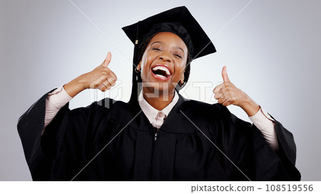 Graduation, woman and student thumbs up for study success, celebration and education, learning or college in studio. Portrait of excited African graduate with yes and like emoji on a white background 108519556