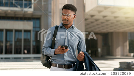 Man, walking and texting from work, corporate clothes and wondering in city, buildings and outside. Professional, employee and leaving on social media, communicating and thinking of day, text or post Man, walking and texting from work, corporate clothes and wondering in city, buildings and outside. Professional, employee and leaving on social media, communicating and thinking of day, text or post 108520089