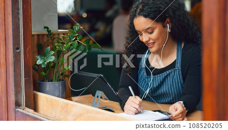 Waitress, woman and writing in cafe with smile, notebook and music for customer order or sales inventory. Barista, person or employee at store window for service checkout, or working on menu in diner 108520205
