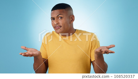 Confused, shrug and portrait of man in studio with why hands on blue background space. Doubt, face and model with dont know emoji for choice, decision or palm scale, questions or asking body language Confused, shrug and portrait of man in studio with why hands on blue background space. Doubt, face and model with dont know emoji for choice, decision or palm scale, questions or asking body language 108520337