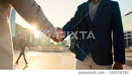 Teamwork, walking or business people shaking hands in city for project agreement or b2b deal. Hiring, outdoor handshake or men meeting for a negotiation, offer or partnership opportunity together 108520792