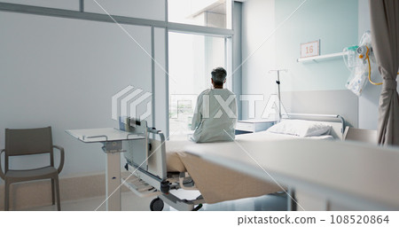 Back, healthcare and a woman on a hospital bed by the window in recovery or waiting for a visit. Medical, cancer and a patient thinking about the future of medicine in a health clinic for treatment 108520864