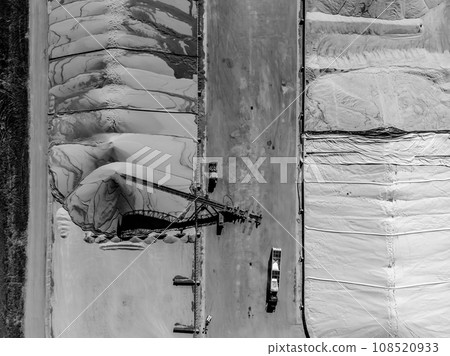 Drone view over grain storage piles being filled and covered Drone view over grain storage piles being filled and covered 108520933
