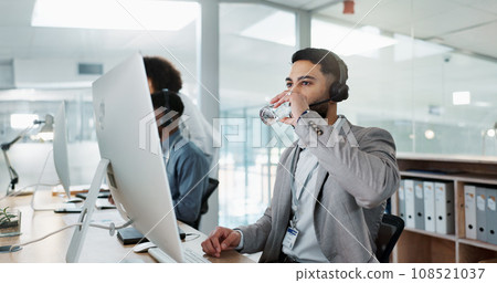 Happy businessman, call center and drinking water in customer service or telemarketing at office. Thirsty man, consultant or agent talking with headphones and drink for online advice, support or help 108521037