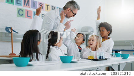 Science, question and students in class with their teacher for learning or to study chemistry. Children, hands raised and education with kids in a laboratory for an experiment of chemical reaction 108521213