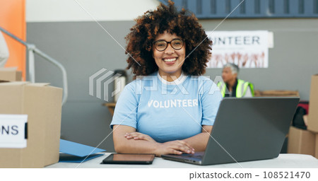 Volunteer woman, laptop and portrait at clothes drive with smile, community service and kindness at desk. Girl, computer and social responsibility with donation boxes, charity and happy for helping Volunteer woman, laptop and portrait at clothes drive with smile, community service and kindness at desk. Girl, computer and social responsibility with donation boxes, charity and happy for helping 108521470