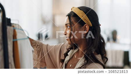 Woman, clothes or hanging rail for fashion choice, decision or store shopping. Indian person, designer style or boutique retail or outfit buying for closet, wardrobe fabric or consumer wholesale mall 108521813