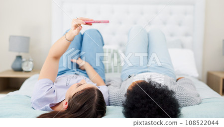 for bonding, resting and chilling together. Cellphone, happy and young lgbtq women taking a picture for memory in the bedroom of modern apartment. for bonding, resting and chilling together. Cellphone, happy and young lgbtq women taking a picture for memory in the bedroom of modern apartment. 108522044