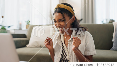 Woman, winner and celebration with laptop in home living room on floor for smile, success or profit on stock market. Trader girl, investor and cheers by computer for goals, bonus or fist for revenue 108522058