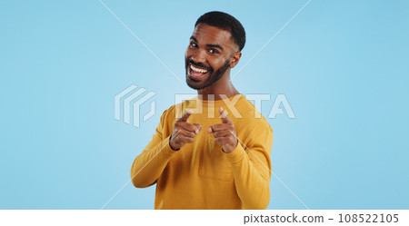Face, excited and black man pointing at you for decision, choice or selection in studio isolated on a blue background mockup space. Portrait, hand gesture and person hiring, recruitment or invitation 108522105