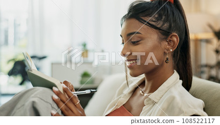 Notebook, woman and writing idea for future, planning and journal for self care, goals and growth. Happy person, book and smiling for notes, agenda and inspirational affirmations on couch at home 108522117