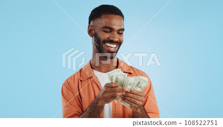 Man, count money and happy in studio with success, bonus or dollar promotion with winning by blue background. Investor, trader or person with cash, salary or savings with smile for financial freedom Man, count money and happy in studio with success, bonus or dollar promotion with winning by blue background. Investor, trader or person with cash, salary or savings with smile for financial freedom 108522751