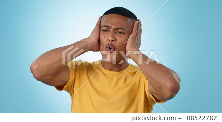 Fail, mistake and hands on face of man in studio with disaster, news or oops gesture on blue background. Crisis, emoji and male model with regret, fear or trauma, body language or conflict anxiety 108522787