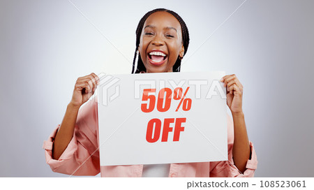 Portrait, sale sign or happy black woman by discount deal, 50 percent off offer or launch ad. Excited, smile or person with board for message, marketing or promotion card on grey background in studio Portrait, sale sign or happy black woman by discount deal, 50 percent off offer or launch ad. Excited, smile or person with board for message, marketing or promotion card on grey background in studio 108523061
