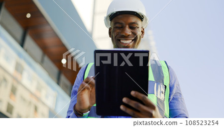 Engineering, man and tablet at construction site inspection, building development and industrial renovation. Excited or happy african worker on digital tech, design software or architecture planning Engineering, man and tablet at construction site inspection, building development and industrial renovation. Excited or happy african worker on digital tech, design software or architecture planning 108523254