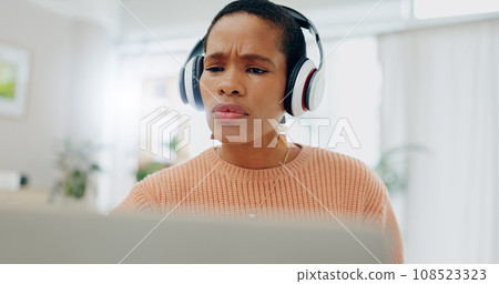 Woman, headphones and frustrated with laptop for remote work from home for confused thinking, error and mistake. African freelancer girl, computer and listen with fail, 404 glitch and stress in house 108523323