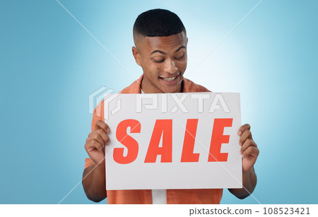 Happy man, sale and poster for promo in studio for mock up on blue background in Cape Town. Male model, person and excited for announcement, notification or board for information of discount in space Happy man, sale and poster for promo in studio for mock up on blue background in Cape Town. Male model, person and excited for announcement, notification or board for information of discount in space 108523421
