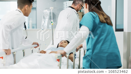 Doctors, patient and people push hospital bed, consulting and talking about healthcare service, wellness or surgery. Medical emergency, cooperation and hospital team, nurses or surgeon helping client Doctors, patient and people push hospital bed, consulting and talking about healthcare service, wellness or surgery. Medical emergency, cooperation and hospital team, nurses or surgeon helping client 108523462