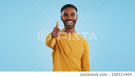 Face, smile and man with thumbs up in studio for support, motivation or vote on blue background. Happy, portrait and excited male model with hand emoji for winning, thank you or success gesture 108523464