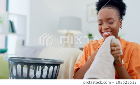 Clean, laundry and black woman with basket in home for clothes, linen or maid with spring cleaning in apartment. Washing, clothing and happy cleaner in house to wash bedding, towel or dirty fabric 108523512