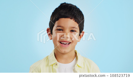 Face, boy child and smile in studio for wellness and confidence on a blue background with positive mindset. Portrait, kid and happiness with casual fashion, joyful and relaxed expression on mockup 108523719