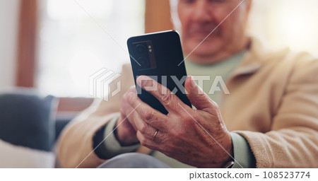 Smartphone and hands of senior man typing online on internet search in retirement home. Phone, elderly person ecommerce and scroll on health website, communication or social media 108523774